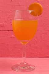 glass juice carrot on wood pink