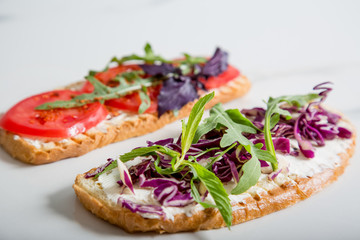 Toast with tomato, arugula, rucola, mozarella cheese, bread and greens