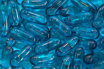 Background - close up of countless blue colourful medicine  pills with shallow depth of field, bokeh