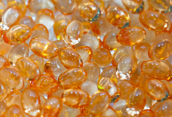 Background - close up of countless colourful orange medicine  pills with shallow depth of field, bokeh