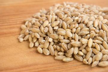 stack of barley pearl in wooden background.