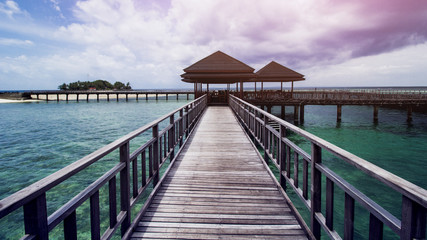 Obraz premium Wooden Beach Dock or Wooden Pier at Beautiful Tropical Beach