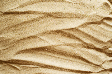 Texture of sand. The drawing of large dabs on sand.