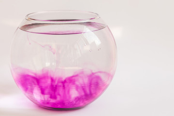 Abstract violet smoke wave in a water in glass vase.