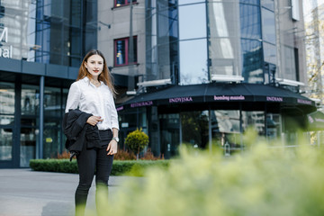 A business woman goes down the street. A girl in a business suit at the office. A wonderful girl in the city.