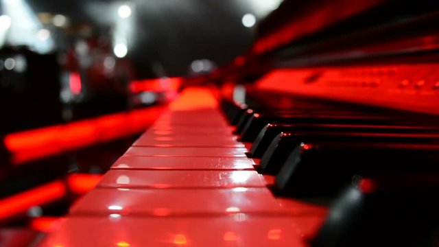 Lights beams on stage with piano and musical instruments