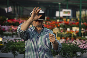 Man with VR glasses in the garden