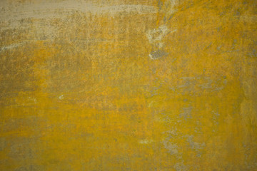 Yellow wall with irregularities in the finish. Background structure.