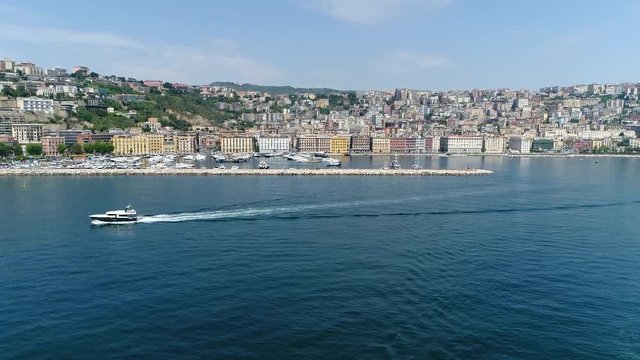 Aerial view flight of cabin cruiser in Naples in Italian Napoli Chiaia Mergellina distric Naples is regional capital of Campania and the third-largest municipality in Italy after Rome and Milan 4k