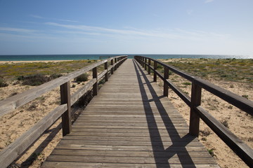 Fototapeta na wymiar Boardwalk to beach in Armacao de Pera