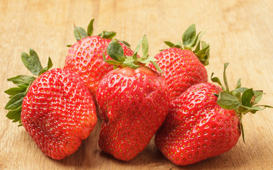 Red fresh strawberry fruits on wooden table.
