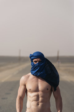 Portrait of caucasian man with turban looking at camera.