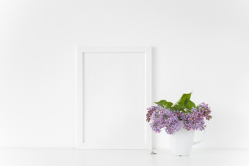 White frame with lilac bouquet on white background