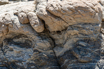Compressed rock layers formation in various colors and thicknesses, on south central coast of the  Mediterranean island Crete, Greece. Nature and Geological science concept