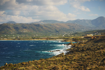 Beautiful seascape with blue sea waves on a rocky beach, Crete, Greece.
