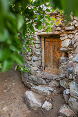 Naklejka premium Old wooden door in stone house in Dah village, Ladakh region, India