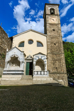 DERVIO, ITALY - APRIL 30th 2018: old Parrocchia Prepositurale Ss.Pietro E Paolo church standing in the center of the Italian village Dervio by the Como lake, lit by the spring sun.