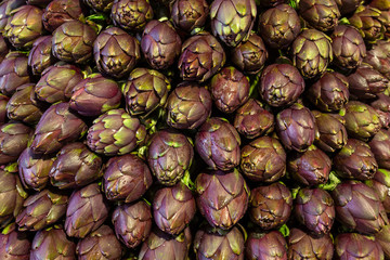Fototapeta na wymiar Fresh artichokes at italian local market close up