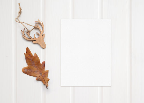 Top view composition made of autumn leaf and wooden reindeer decoration top view, copy space.