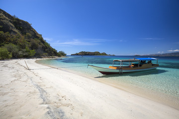 A boat on an empty beach in the Seventeen Island National Park near Riung, Indonesia.