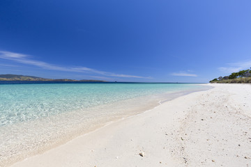 Clear water on an empty beach in the Seventeen Island National Park, Flores, Indonesia.