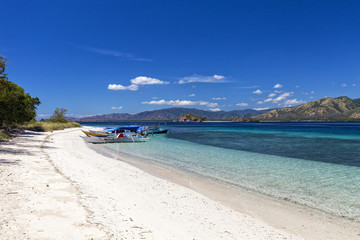 Boats docked on a beach in the Seventeen Island National Park, Flores, Indonesia.