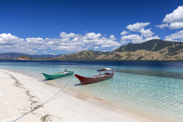 A red and green boat in the tropical waters of the Seventeen Island National Park, Indonesia.
