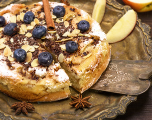 baked round apple pie on an iron plate