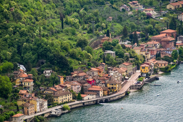 Fototapeta na wymiar Fiumilatte sergio river flowing through the village of Varena, Italy