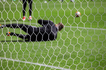 goalkeeper behind the net of the gate