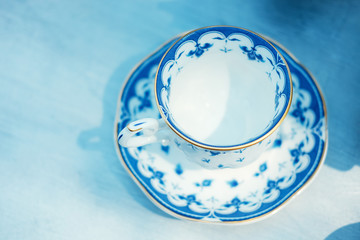 White and blue chinawear on blue wooden table