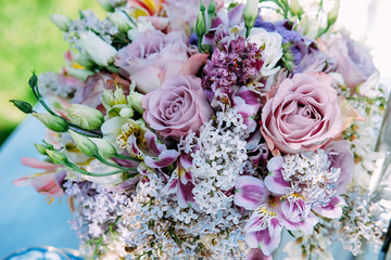 Wedding bridal bouquet made of lilac flowers, eustoma, roses and tiger lily