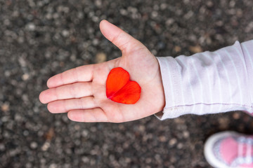 Young girl showing a heart
