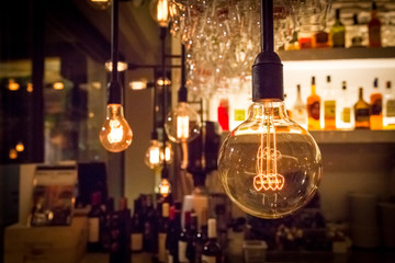Vintage lamp bulb with bar or cafe night abstract background