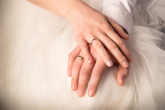 Hands of just married bride and groom with rings. Wedding photograph