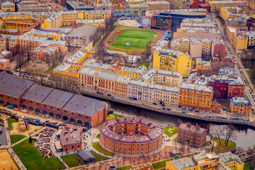 Beautiful above view of roofs of buildings at historical center close to Moyka River in Saint Petersburg, summer day, lot of old buildings and industrial zone at the horizon