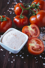 Organic tomatoes on a wooden background