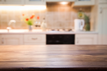 Fototapeta na wymiar blurred kitchen interior with wooden desk space