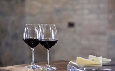 two glasses of red wine on  kitchen table