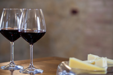 two glasses of red wine on  kitchen table