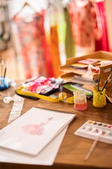 workshop of a fashion designer, draw of a new model on the desk