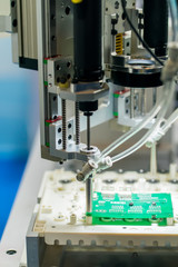 robot machine tool at printed circuit boards industrial manufacture factory
