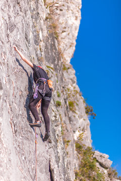 Rock climbing on vertical wall