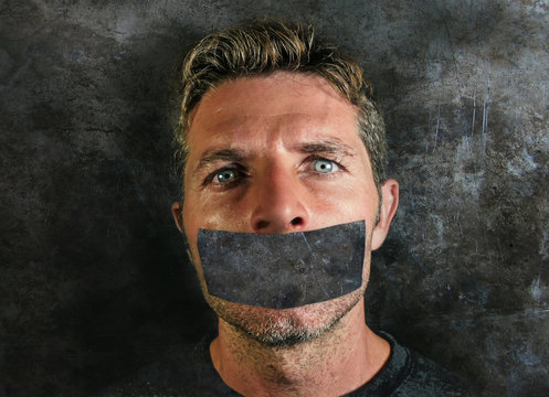 Man With Mouth And Lips Sealed Covered With Adhesive Tape In Censorship Coerced Freedom Of Speech And Forced Silence And Secrecy Concept