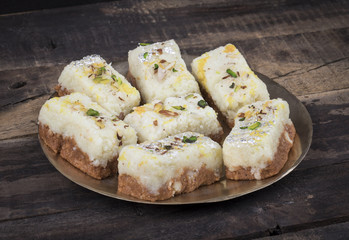 Indian Diwali Sweet Food Kalakand Also Know as Halwa or Mawa Kalakand is a Creamy Delicacy Made From Paneer or Cottage Cheese, The Dish Originated in Alwar, Rajasthan. Kalakand on Wooden Background