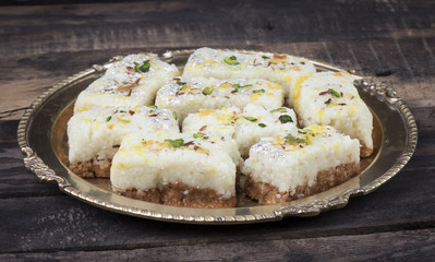 Indian Diwali Sweet Food Kalakand Also Know as Halwa or Mawa Kalakand is a Creamy Delicacy Made From Paneer or Cottage Cheese, The Dish Originated in Alwar, Rajasthan. Kalakand on Wooden Background