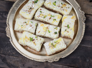 Indian Diwali Sweet Food Kalakand Also Know as Halwa or Mawa Kalakand is a Creamy Delicacy Made From Paneer or Cottage Cheese, The Dish Originated in Alwar, Rajasthan. Kalakand on Wooden Background