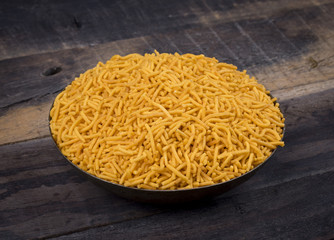 Indian Namkeen Food Spicy Yellow Sev on Vintage Wooden Background