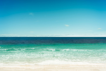Fototapeta na wymiar Tropical beach and sea with sunny sky .