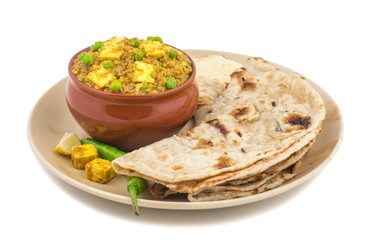 Indian Cuisine Mattar Paneer is a Vegetarian North Indian Dish Consisting of Peas And Paneer in a Tomato Based Sauce, Spiced with Garam Masala. It is often Served with Indian type of Tandoori Roti - obrazy, fototapety, plakaty